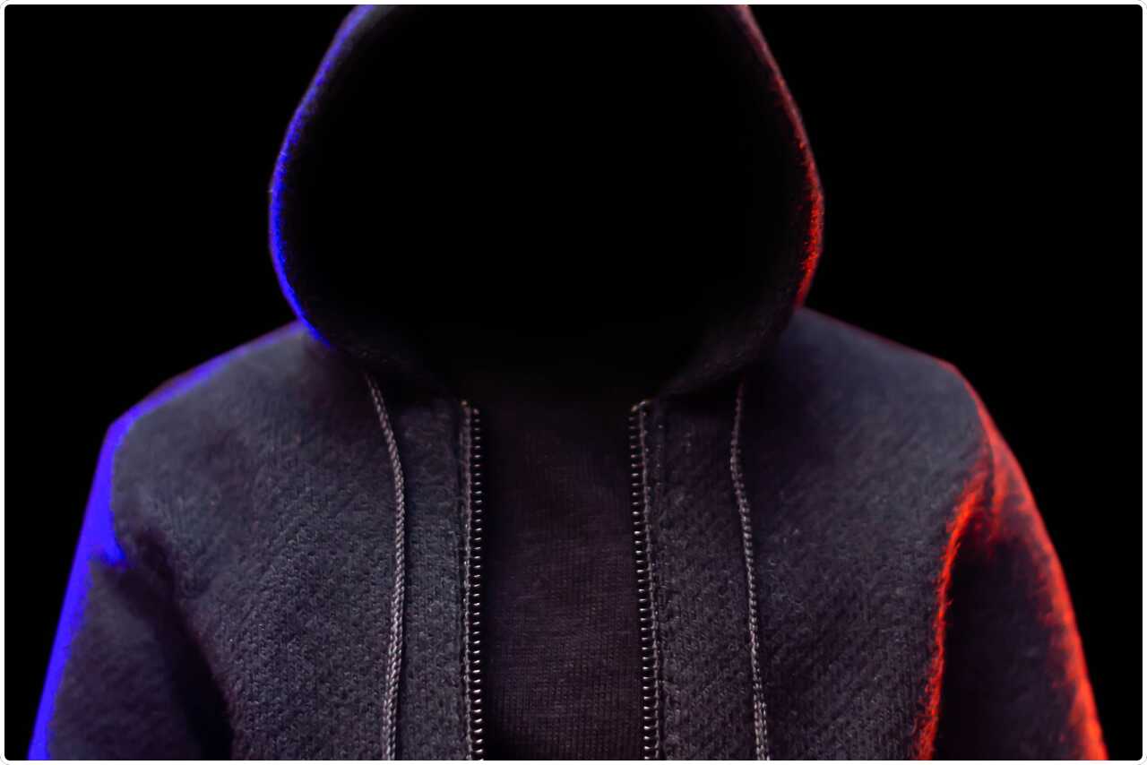 Mysterious character in a hooded cloak, appearing enigmatic like a hacker